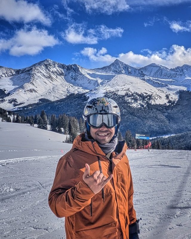 Ashwin on a ski run under a clear blue sky